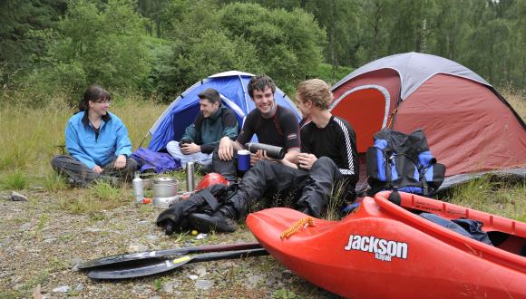 Campers with canoes outside tent at Loch Tummel.